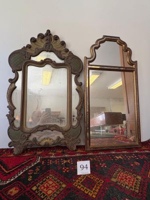 two mirrors that are sitting on a table