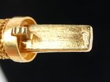 a close up of a gold ring on a black background