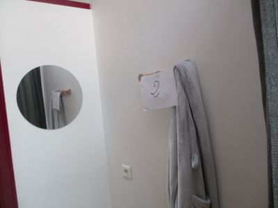 une serviette accrochée au mur à côté d'un miroir