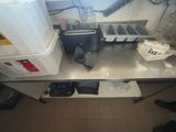 a picture of a kitchen with a lot of clutter on the counter
