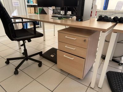 a desk with a chair and a computer monitor on it