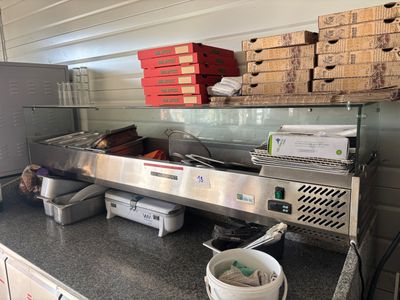 une photo d'une cuisine professionnelle avec beaucoup d'aliments sur le plan de travail