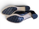 pair of black leather shoes on white surface with white background