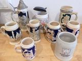 several beer mugs are lined up on a wooden table