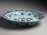 a blue and white bowl with floral designs on it