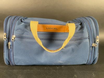 LANCEL. Sac de voyage en toile bleue marine et cuir marron