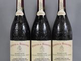 three bottles of wine are lined up on a table