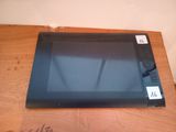 a black tablet computer sitting on a wooden table
