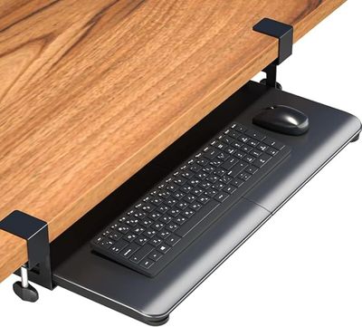 a computer desk with a keyboard and mouse on it