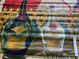 a large poster of a bottle of liquor on the wall