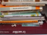 many books stacked on top of each other on a table
