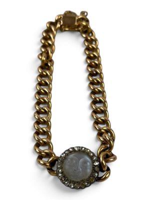 a close up of a necklace on a white background