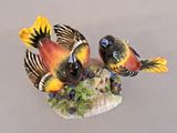 two birds that are sitting on top of a rock