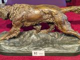statue of a golden retriever on a rock on a red carpet