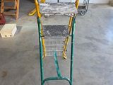 an image of a green and yellow ladder in a garage