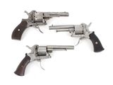 two revolvers are shown on a white surface with a white background