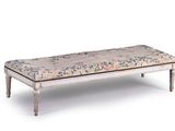 a white bench with a floral upholstered seat