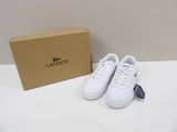 a pair of lacoste white tennis shoes in a box