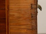 a close up of a wooden drawer with a bird on it