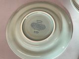 a white plate with a poem on it sitting on a table