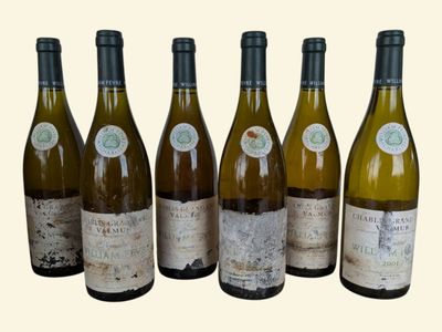 six bottles of wine are lined up in a row on a table
