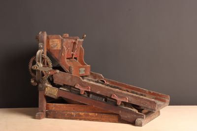 a wooden machine that is sitting on a table