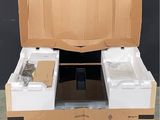 a cardboard box that has two white containers inside of it