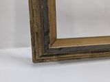 an old wooden picture frame with a white background and a white wall