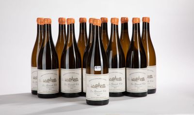 six bottles of wine are lined up in a row on a table