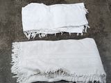 two white towels on the ground next to each other