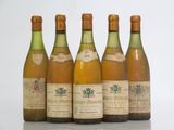 six bottles of wine are lined up on a table