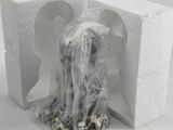 a small figurine of a woman sitting in a box