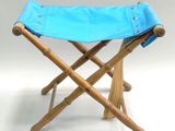 a small stool with a blue cover on it