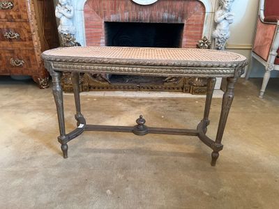 a table with a basket on top of it in front of a fireplace