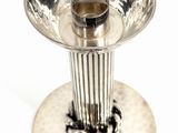 a silver candle holder on a white background