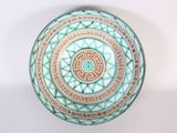 a bowl with a design on it on a table