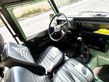 a green car with a black leather seat and steering wheel