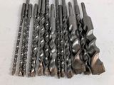 a bunch of drill bits sitting on top of a table