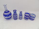 an image of a group of blue glass objects on a white surface