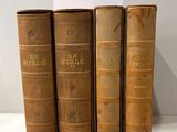 three old books are stacked on top of each other on a table