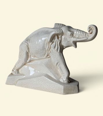 statue of an elephant with a long tusk on a white background