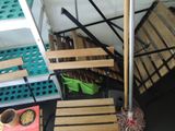 a pile of boxes and crates sitting on the floor next to a staircase