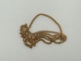 a close up of a gold necklace with a chain on a white surface