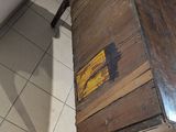 a wooden table with a wooden top on a tiled floor