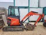 a small excavator that is sitting in the dirt