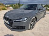 the audi tt coupe is parked in a parking lot