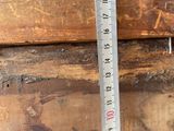 a measuring tape on a piece of wood that is being used to measure the width of a piece of wood