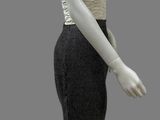 female mannequin in a black and white dress on a gray background
