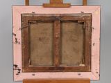 an old wooden easel with a painting on top of it