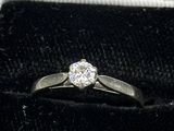 a diamond ring sitting in a box with a ring in it